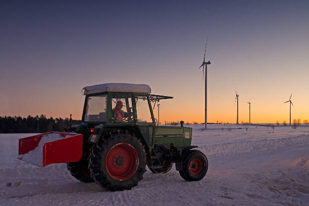 Traktor vor Windrädern
